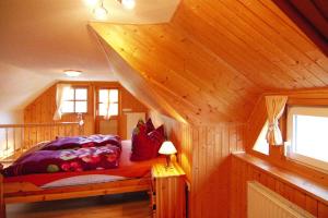 a bedroom with a bed in a wooden cabin at Apartment, Wieck am Darss in Wieck