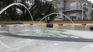 a bath tub with two water faucets at Hotel Europa in San Bartolomeo al Mare