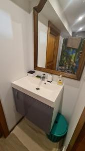 a bathroom with a sink and a mirror at Le bonhomme proche de Kaysersberg et du lac blanc in Le Bonhomme