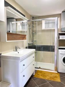 a white bathroom with a sink and a shower at Villa Maslina in Sutivan