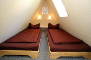 two beds in a small room in a attic at Holiday home Stork's Nest 2, Falkensee in Falkensee