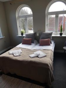 a bedroom with a large bed with two towels on it at Gredstedbro Hotel in Gredstedbro