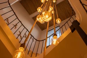 a chandelier is hanging from a staircase with at Le S in Argelès-sur-Mer