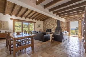 a living room with a table and a fireplace at Villa Coric in Inca
