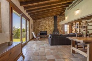 a living room with a couch and a fireplace at Villa Coric in Inca