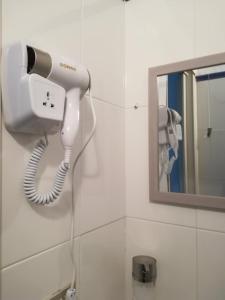 a hair dryer on a wall next to a mirror at A casa mia in Vietri sul Mare