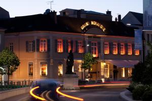 a large building with a clock on the front of it at Best Western Premier Grand Monarque Hotel & Spa in Chartres