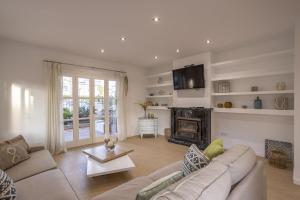 a living room with a couch and a fireplace at House Can Toni in Port d'Alcudia