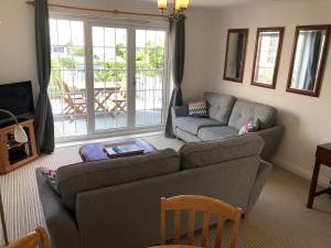 a living room with a couch and a table at The Albany Apartments in St. Peter Port