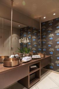 a kitchen with two counters and a wall with blue clouds at Palazzo Salomone in Siracusa