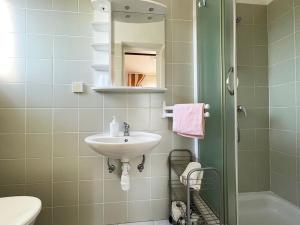 a small bathroom with a sink and a shower at Apartments Near the sea Barbat in Barbat na Rabu +59 photos