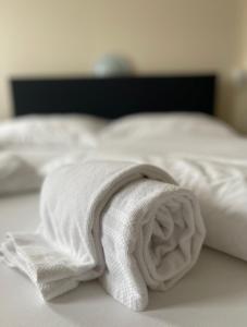 a white towel sitting on top of a bed at Boutique Hotel & Restaurant Bären Ringgenberg in Ringgenberg