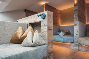 a room with a couch and two beds in it at La Cort My Dollhouse - Adults Only in Ortisei +62 photos