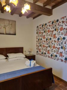 a bedroom with a bed and a floral wall at Il Castello di Monteggiori in Camaiore