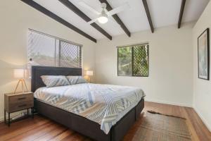 a bedroom with a bed and a window at William St 1 70 Moffat Beach in Caloundra