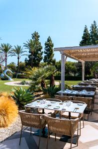a patio with tables and chairs and a gazebo at Boho Club in Marbella