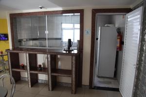 a kitchen with a sink and a refrigerator at Hotel Piramide - Dois de Julho (Adult Only) in Salvador