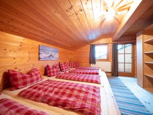 a bedroom with two beds in a log cabin at Balbach Alm Apartment in Oetz