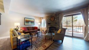 a living room with a couch and a fireplace at Mammoth Creek #9 condo in Mammoth Lakes