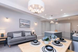a living room with a couch and a table at Enfield House - Charming, Modern and Light 4bed in Nottingham