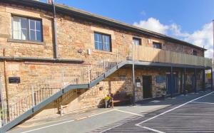 a brick building with a staircase on the side of it at Crows Hotel in Lancaster
