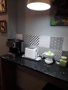 a kitchen counter with a counter top with a toaster at Bonito piso en Puerto de Sagunto in Puerto de Sagunto