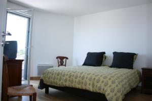 Ένα ή περισσότερα κρεβάτια σε δωμάτιο στο Appartement Le Rev
