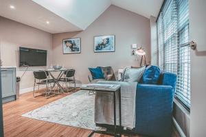 a living room with a blue couch and a table at 63 Chester Rows City Centre Apartment B by Rework Accommodation in Chester