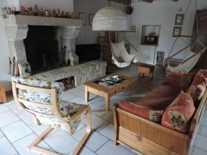een woonkamer met een bank en een open haard bij La sérénité in Grazac