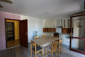a kitchen with a wooden table and chairs in it at Antodo Alen in Novalja +84 photos