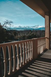 a balcony with a view of snow covered mountains at Resort Bacca Blu in Bricherasio