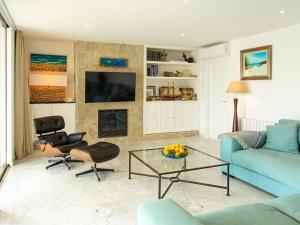 sala de estar con sofá azul y chimenea en Es turó, luxury beachfront apartment in Colonia San Jordi en Colonia de Campos