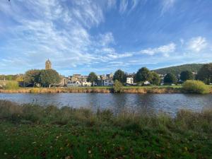 a body of water with a town in the background at Tweed Green Holiday let in Peebles