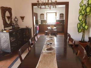 uma sala de jantar com uma grande mesa de madeira com cadeiras em Casa de Antaño em San Cristóbal El Bajo