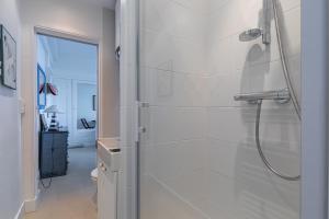 a bathroom with a shower with a glass at Le Celtic in Saint-Cast-le-Guildo