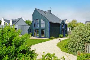 a blue house with a black roof at Holiday Home in Penestin near La Mine d'Or Beach in Pénestin