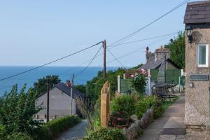 a small street in a small town with houses at Windy Ridge Terrace with beautiful sea views, North Wales Coast in Old Colwyn