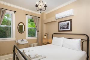 een slaapkamer met een bed en een wastafel bij Pine Cottage Bed & Breakfast in Mackinac Island
