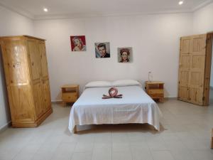 een slaapkamer met een bed en wat foto's aan de muur bij Unique Owl Apartments in Sanyang +63 foto's