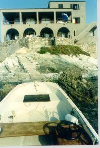 a boat sitting in front of a building at CASA SUPRA U MARE in Centuri