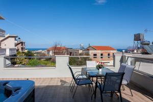 a patio with a table and chairs on a balcony at Vista Magica in Chania Town