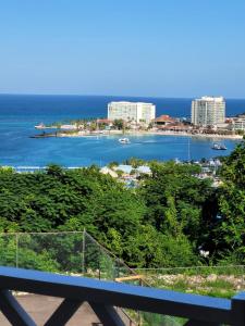 a view of the ocean from a balcony at Secluded Studio@Sky Castles, Columbus Heights, Ocho Rios in Ocho Rios