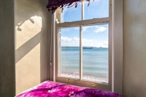 a window with a view of the ocean at Fred's Place - Kingsand in Kingsand