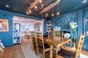 a dining room with blue walls and a wooden table at Fred's Place - Kingsand in Kingsand