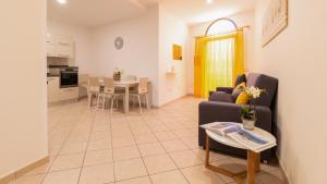 a living room with a couch and a table at Sardinianworld - Il Lentischio in Càbras