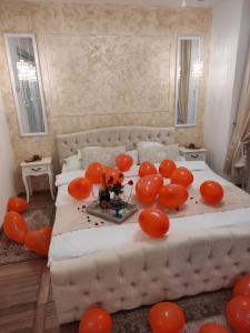 a bedroom with a bed with red balloons on it at Penthouse Luxury in Reşiţa