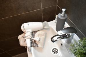 a hair dryer sitting on top of a sink at The APEX Residences in Budapest