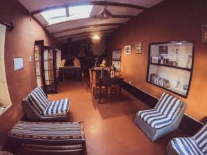 a living room with two chairs and a piano at B&B Sun Gate in Ollantaytambo