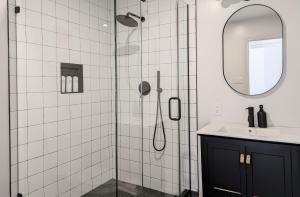 a bathroom with a shower with a sink and a mirror at Acorn Bungalow - Luxury Cabin, Catskills, Windham Mountain, Hunter Mountain in Cairo +23 photos