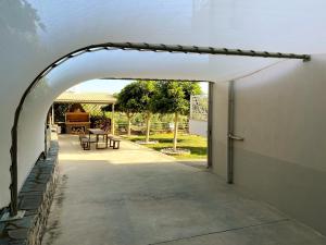 an archway over a walkway leading to a patio at Oasis Villa - Maisonette A in Almirón